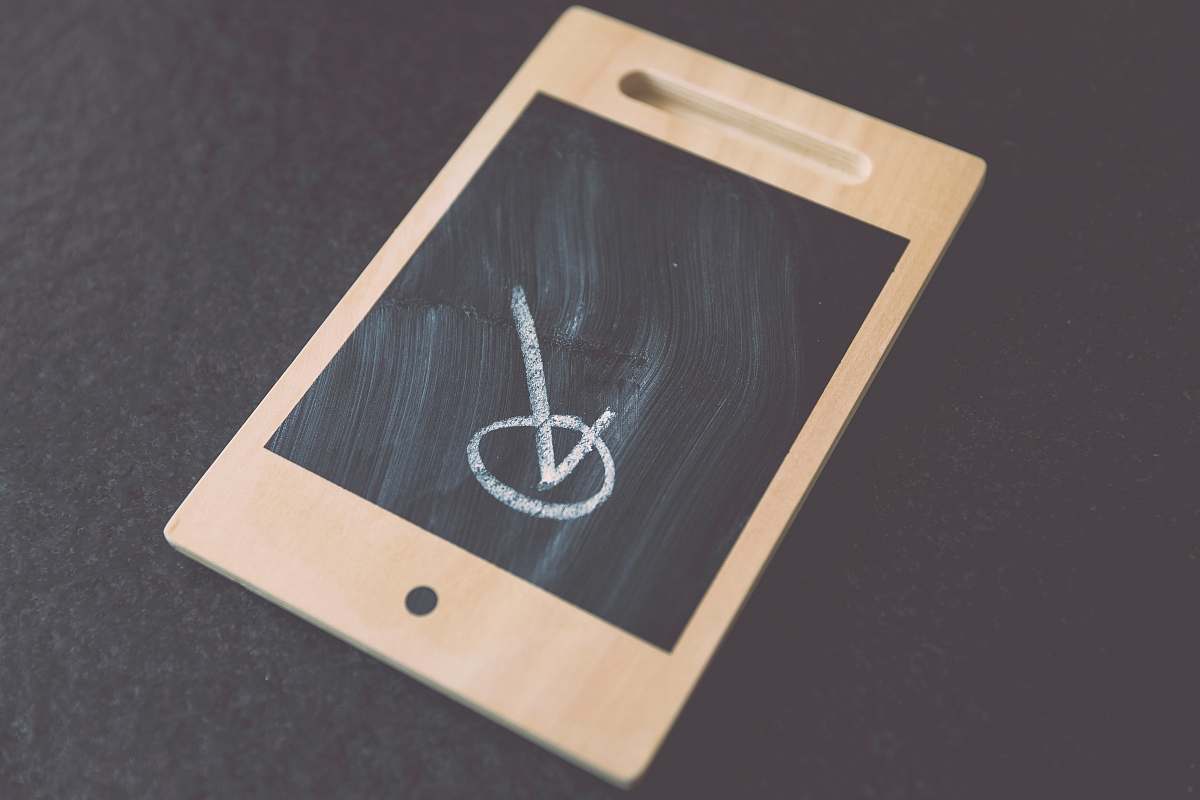tablet check illustration on wooden board digital