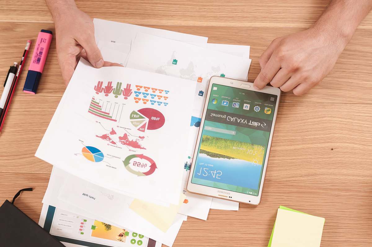 work person holding white Samsung Galaxy Tab tablet