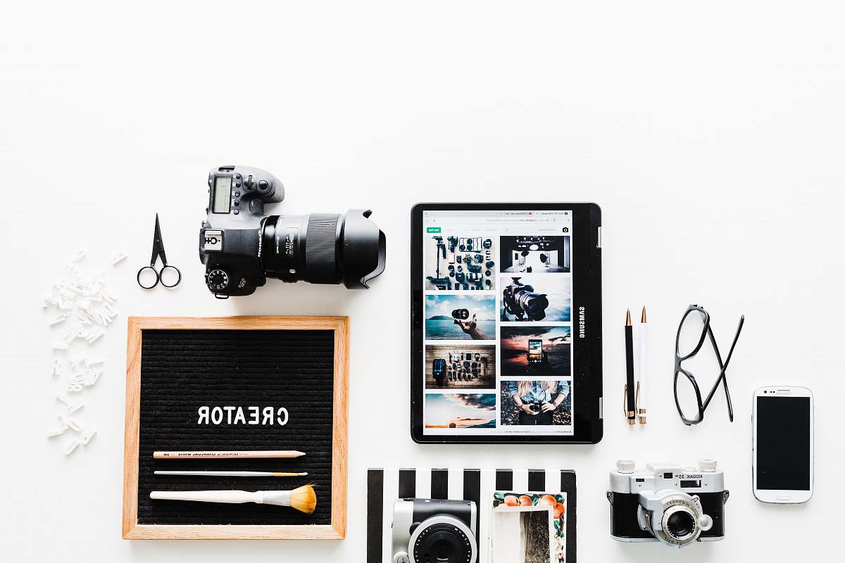 poster flat view of cameras beside computer tablet and smartphone collage
