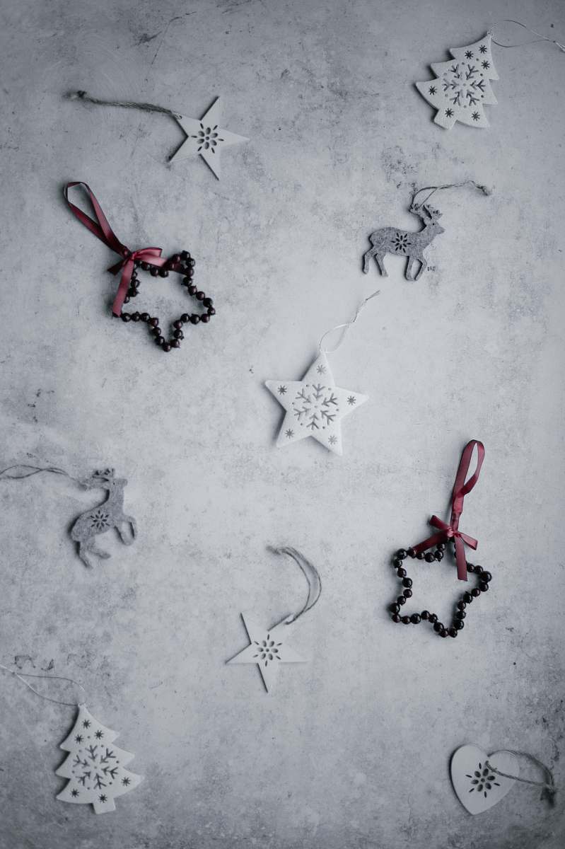 grey assorted Christmas decor lot lying on white panel stencil