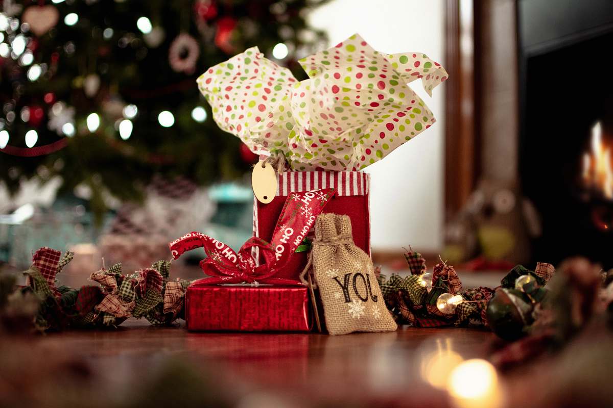 paper assorted Christmas decors on brown floor gifts
