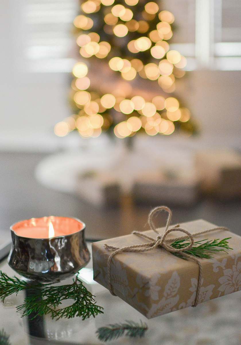 holiday brown gift box beside stainless steel votive candle gift