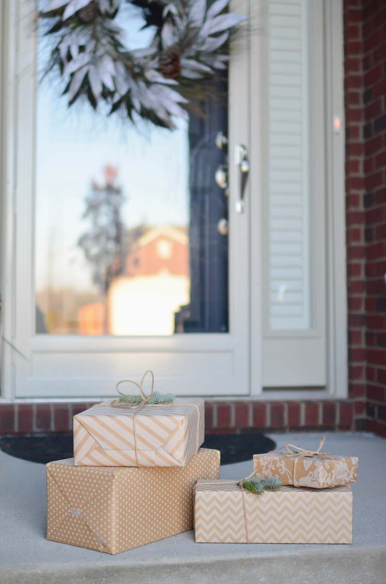 gift four brown gift boxes near white door porch