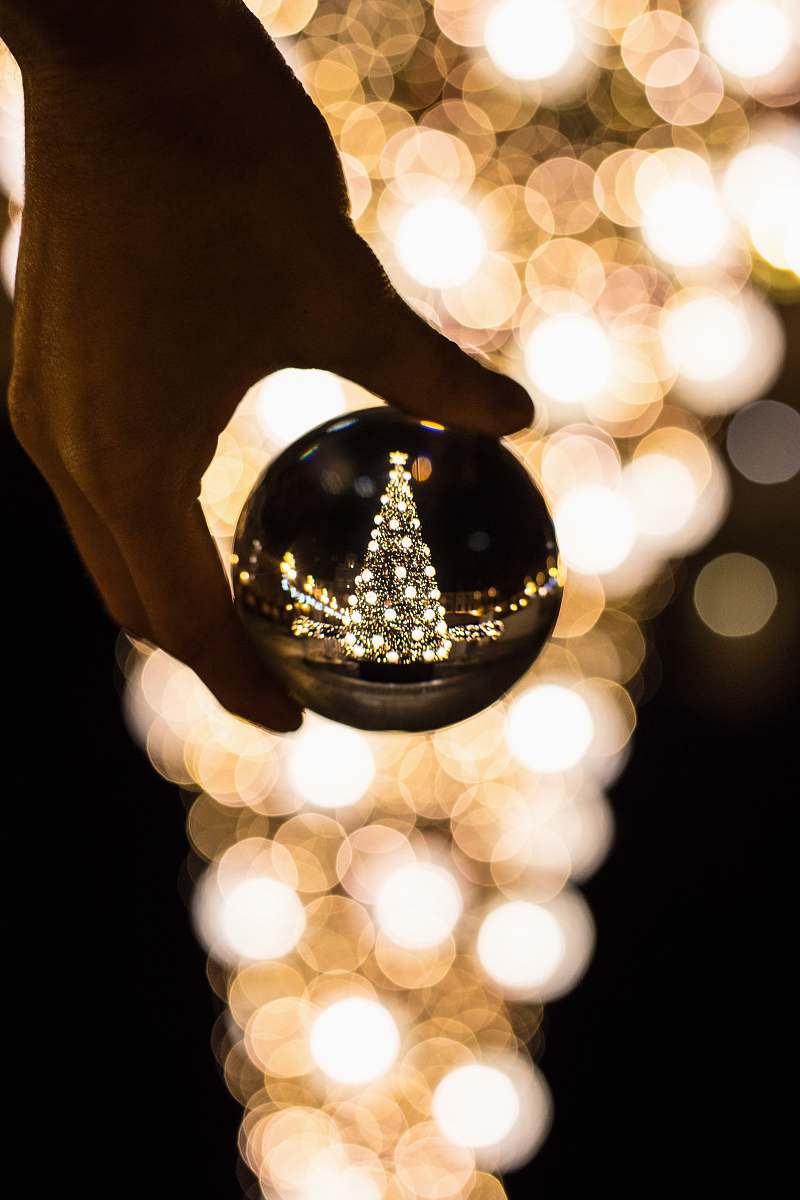 crystal person holding glass bauble lamp