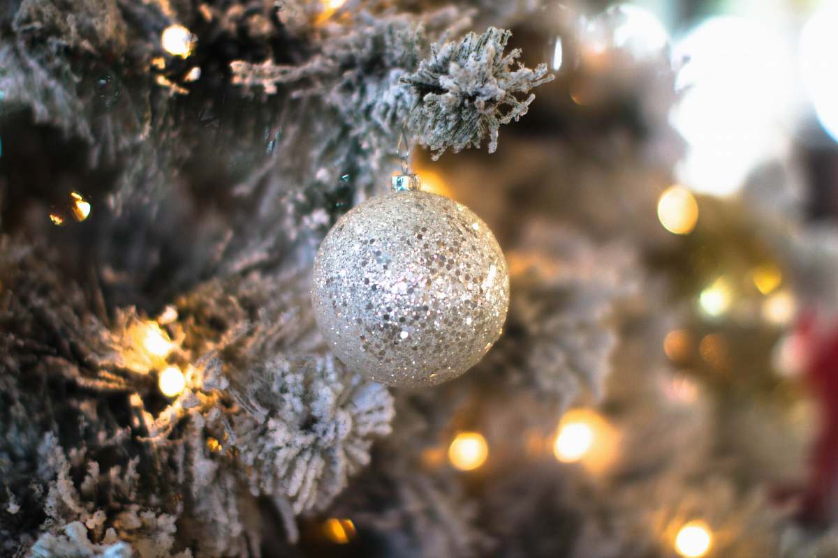 snow round gray bauble hanging on Christmas tree frost
