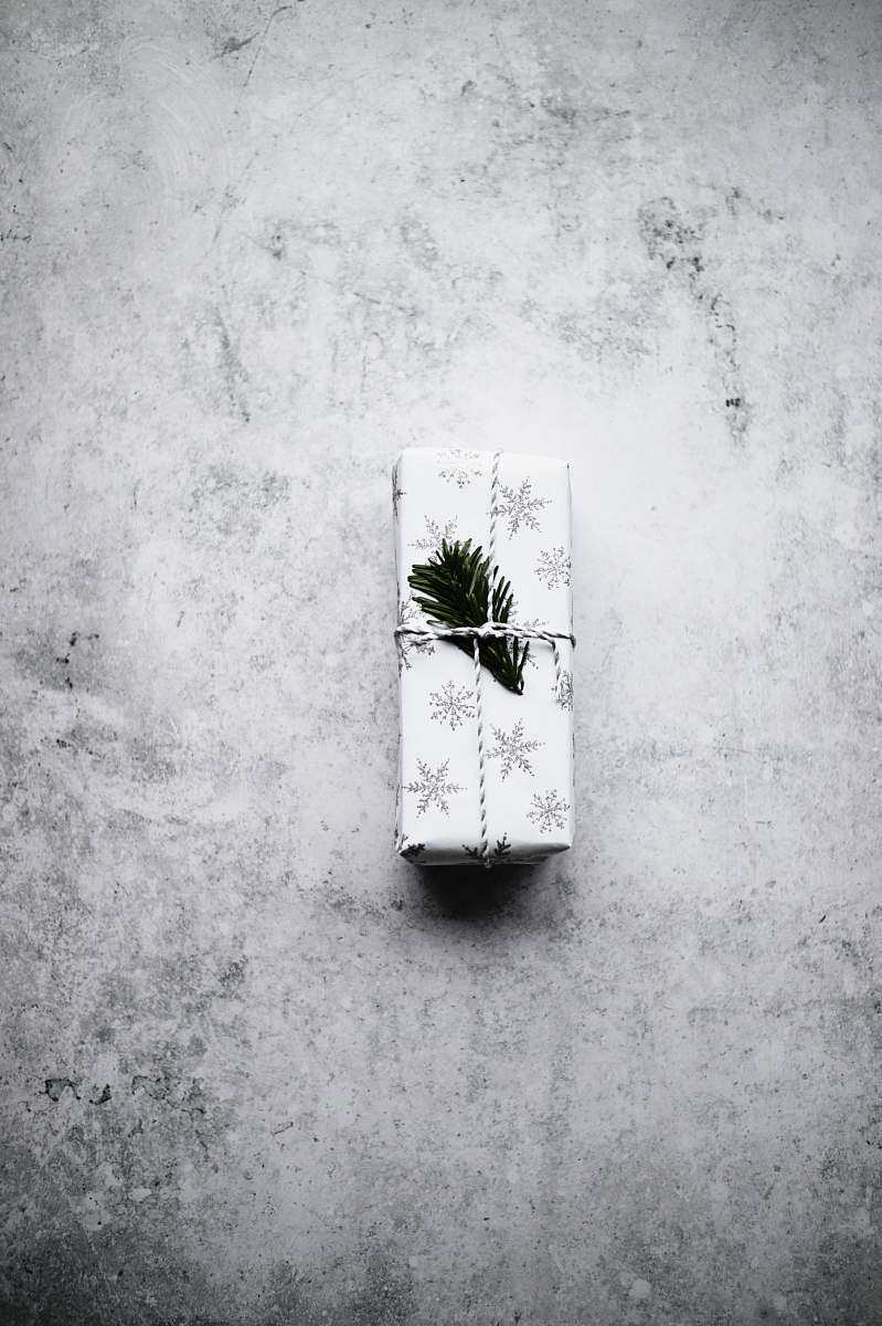grey white and black snowflake print gift box on gray surface wall