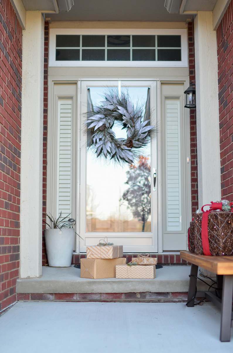 window wreath hanging on full-lite door of house holiday