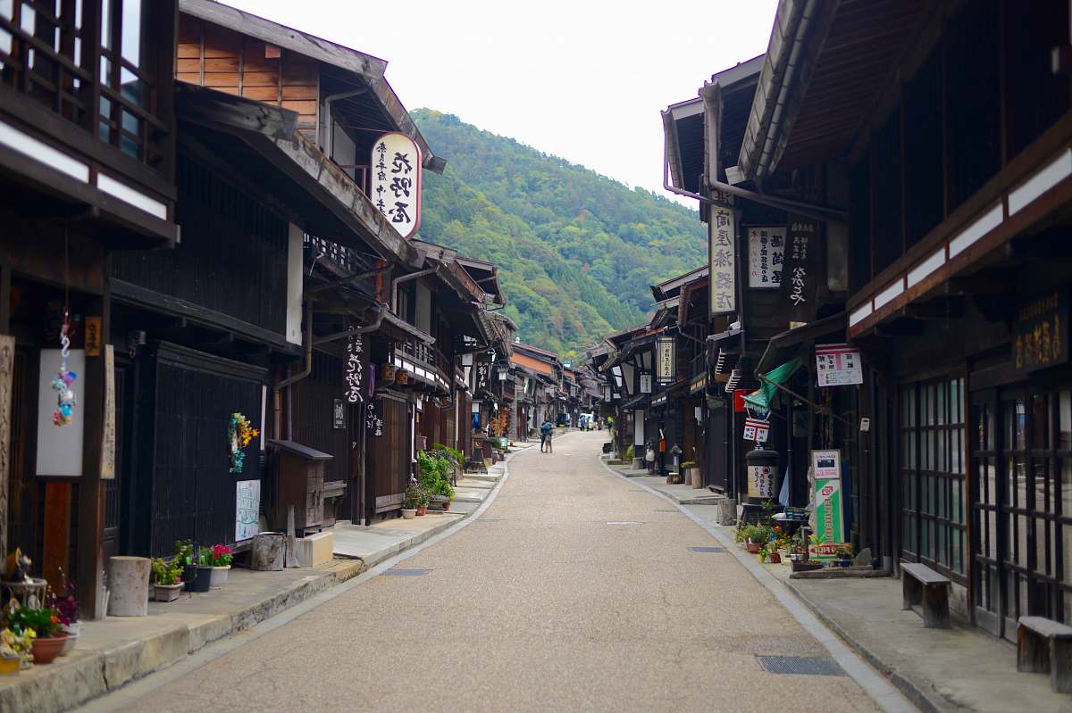 building person between houses during daytime road