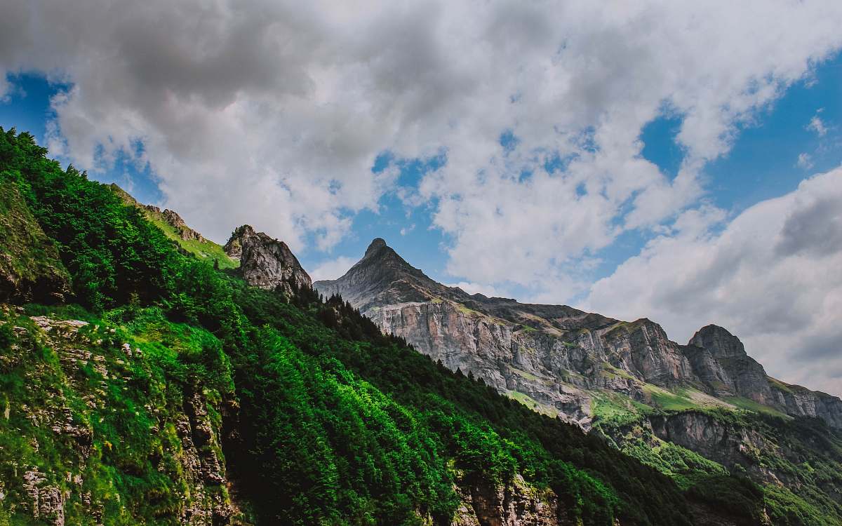 alpes green covered mountains under blue and white sky france