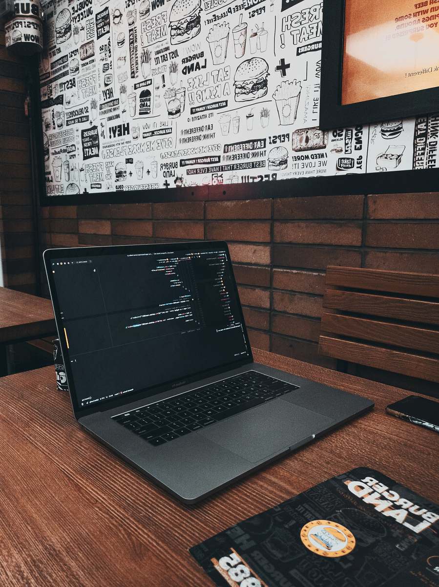 electronics MacBook Pro on brown wooden table pc