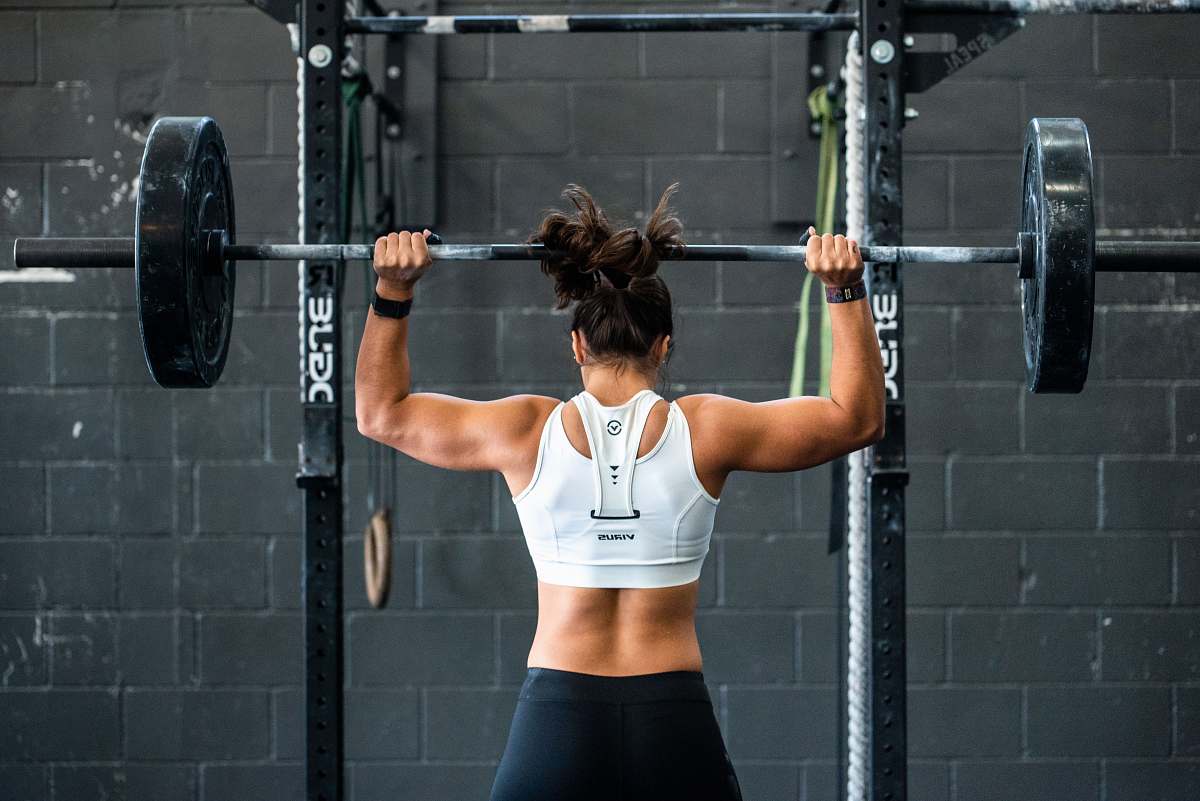 sport woman doing weight lifting exercise