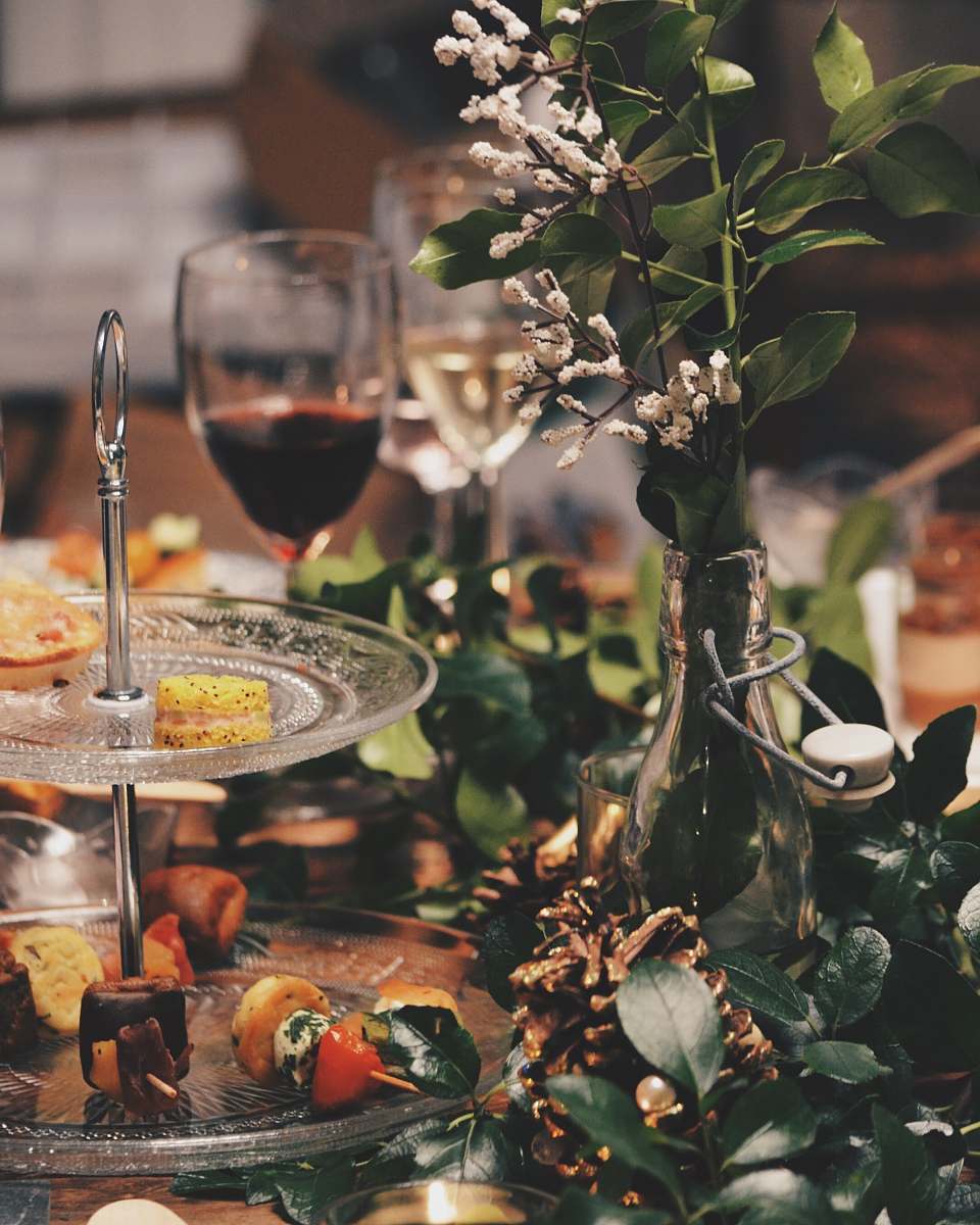 glass clear glass 2-tier plate beside flower arrangement wine