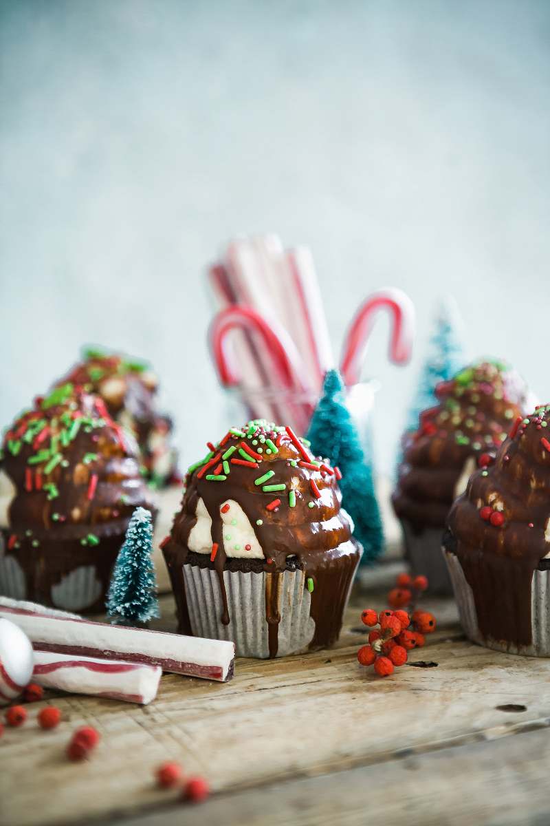 christmas cupcakes with sprinkles on table chocolate