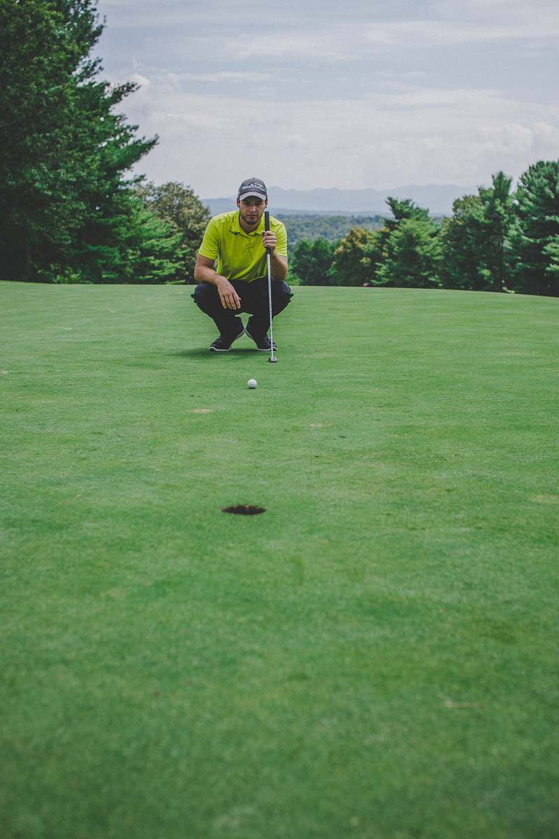 sport man playing golf sitting beside trees sports
