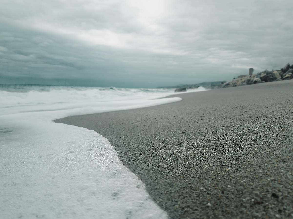 sea beach under cloudy sky beach