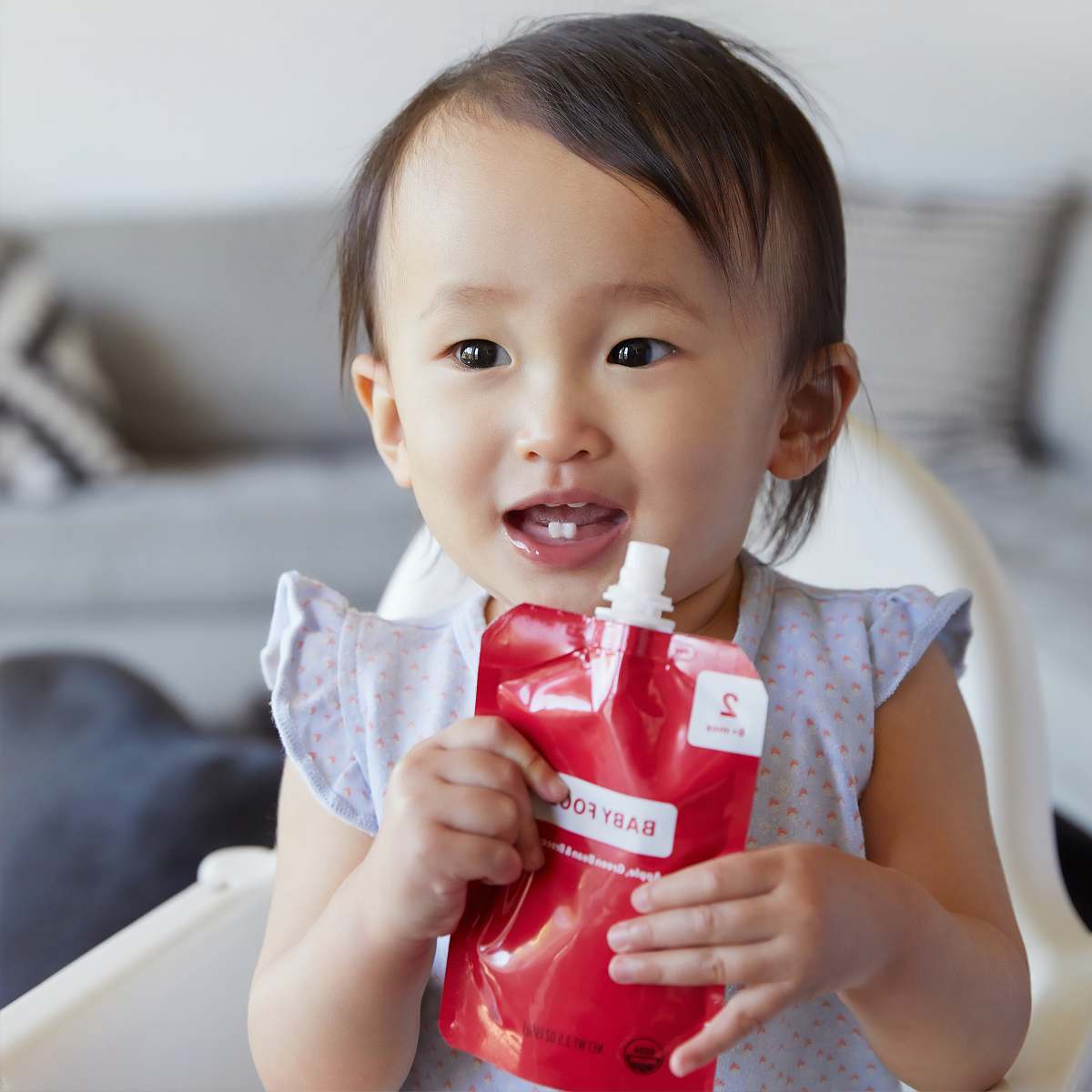 person baby drinking juice pack baby