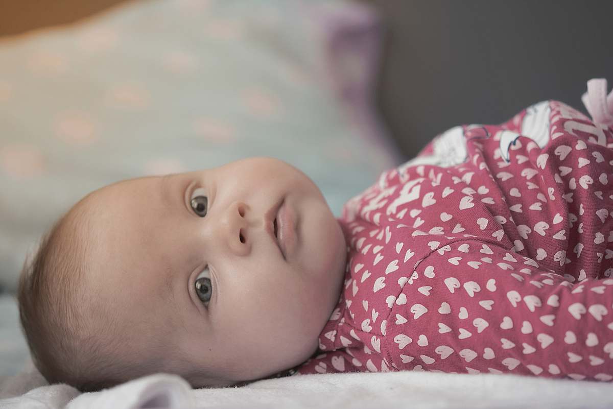 person baby lying on bed people