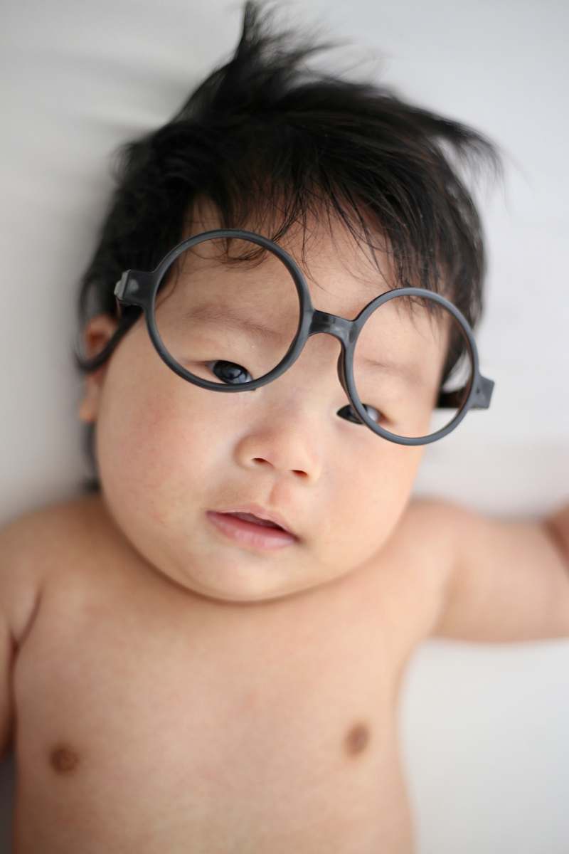 person baby lying on white cloth face
