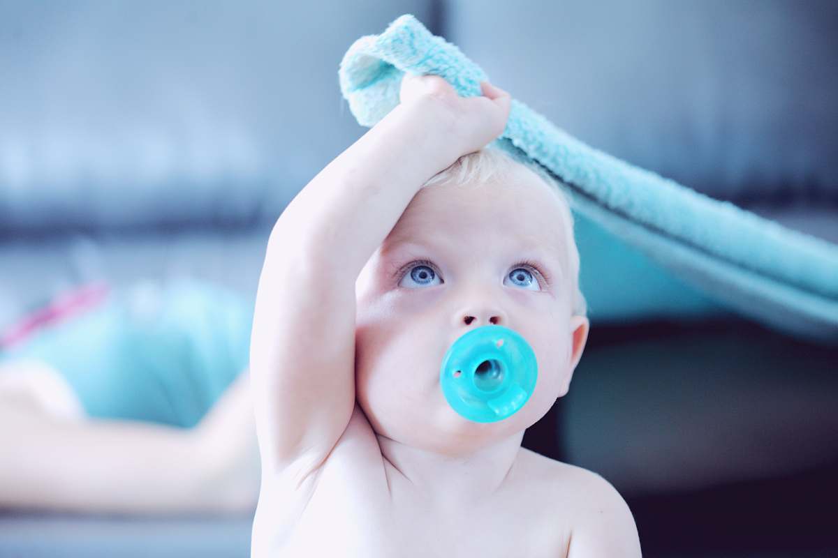 person baby with pacifier in mouth people