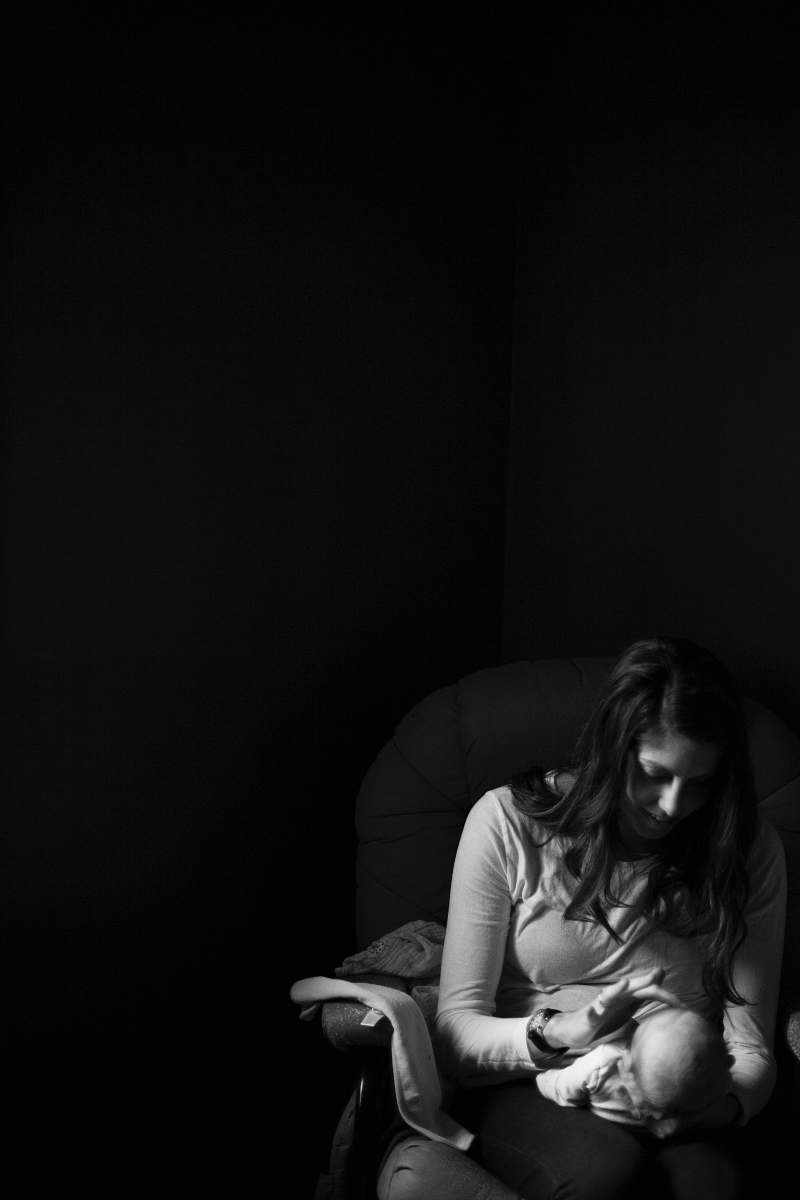 people grayscale photo of woman holding a baby on her right hand while her left hand touching baby's face black-and-white