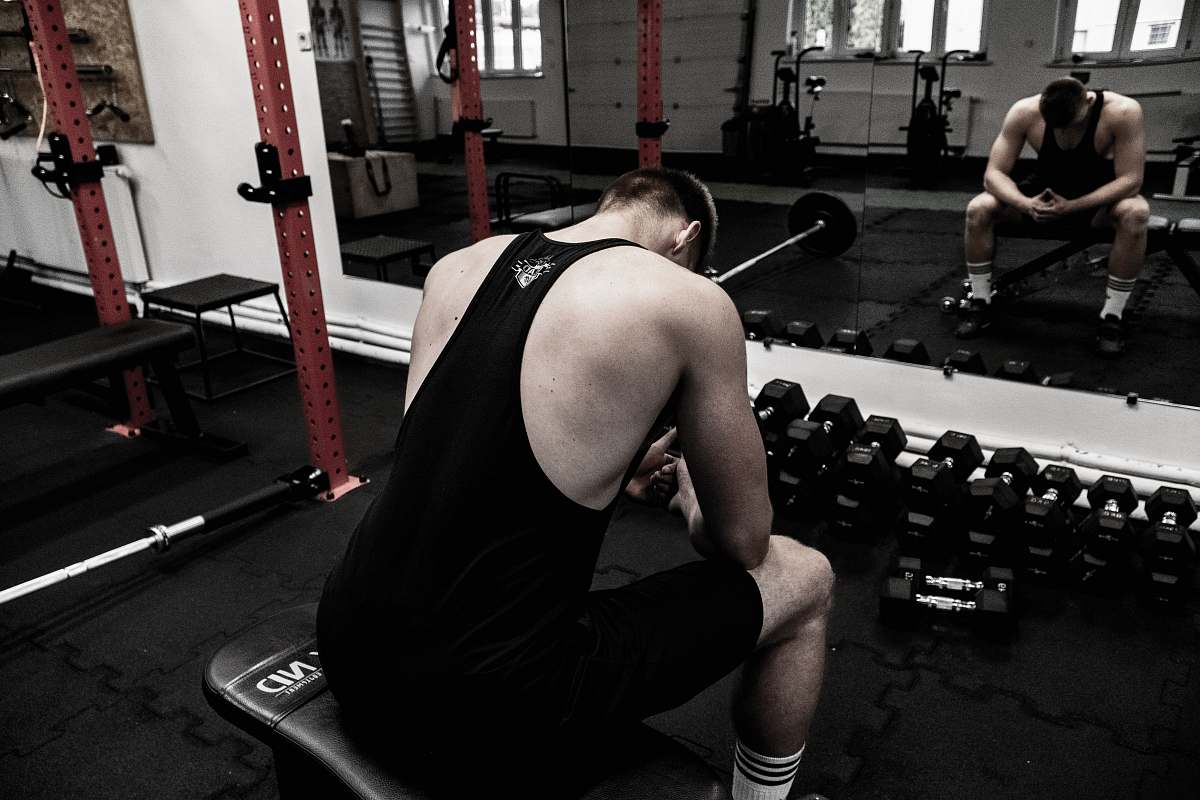 fitness man sitting in gym exercise
