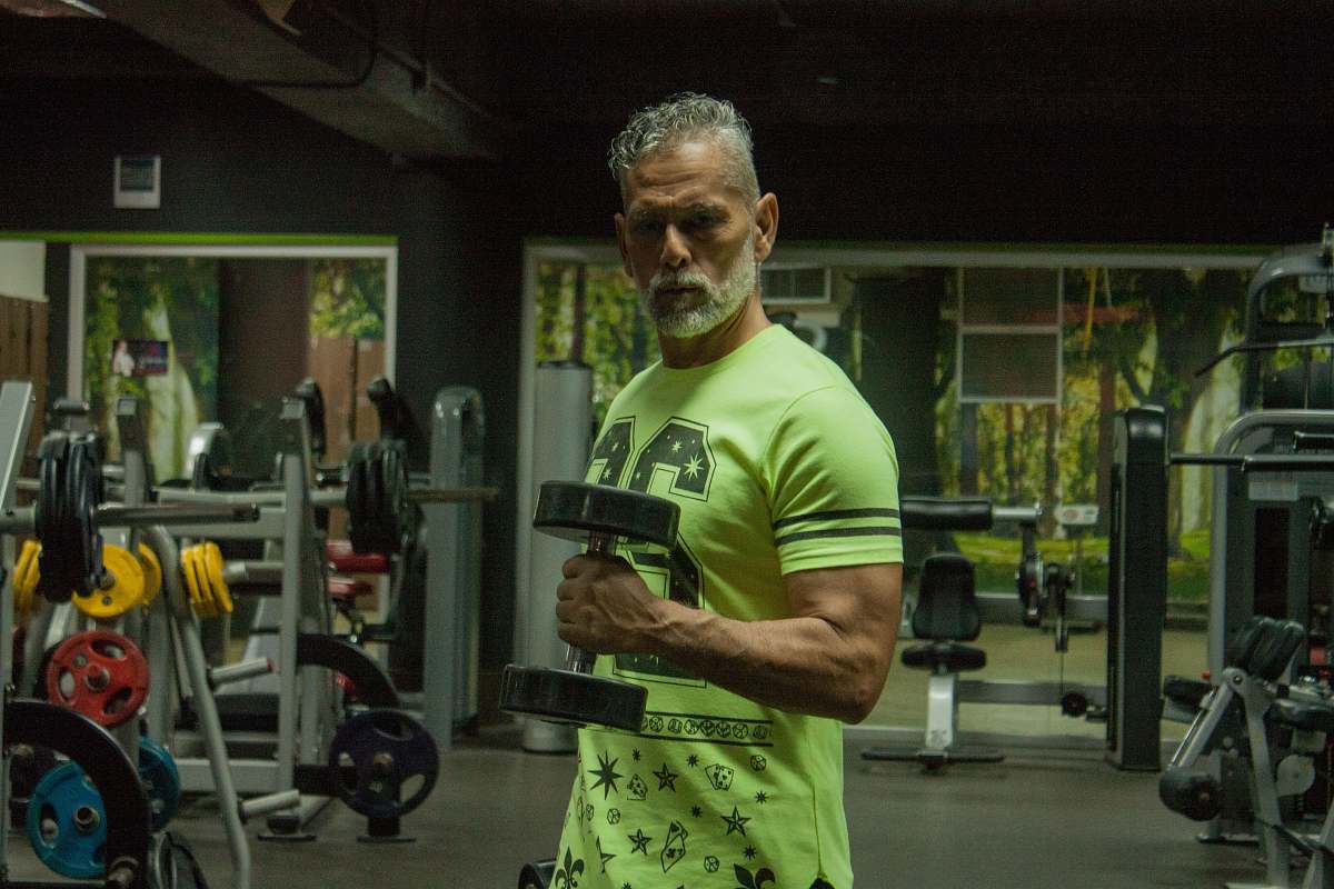 person man wearing yellow and black crew-neck t-shirt fitness
