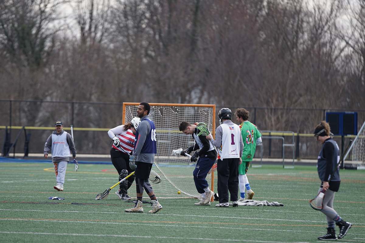 person people playing sports game on field during daytime team sport