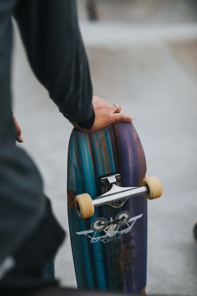 sports person holding skateboard skateboard