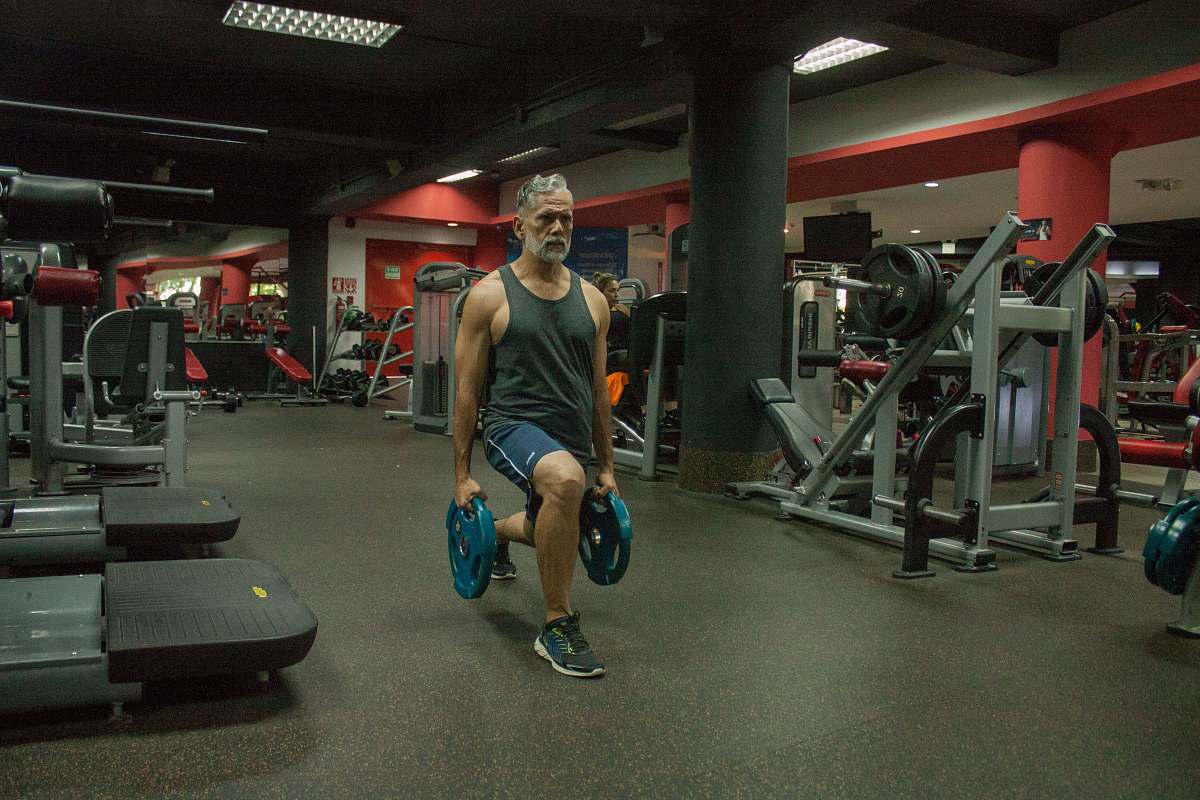 fitness person lifting weight in a room gym