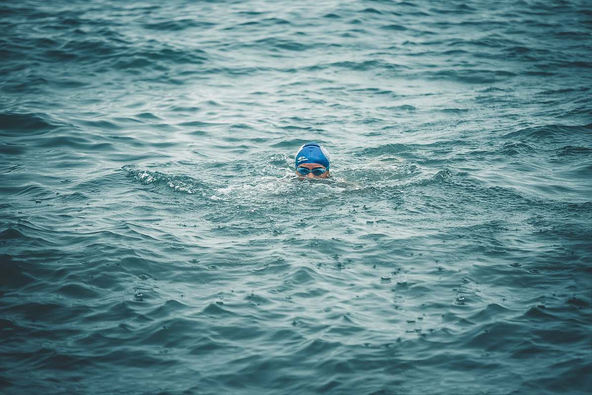 person person swimming on body of water during daytime sport