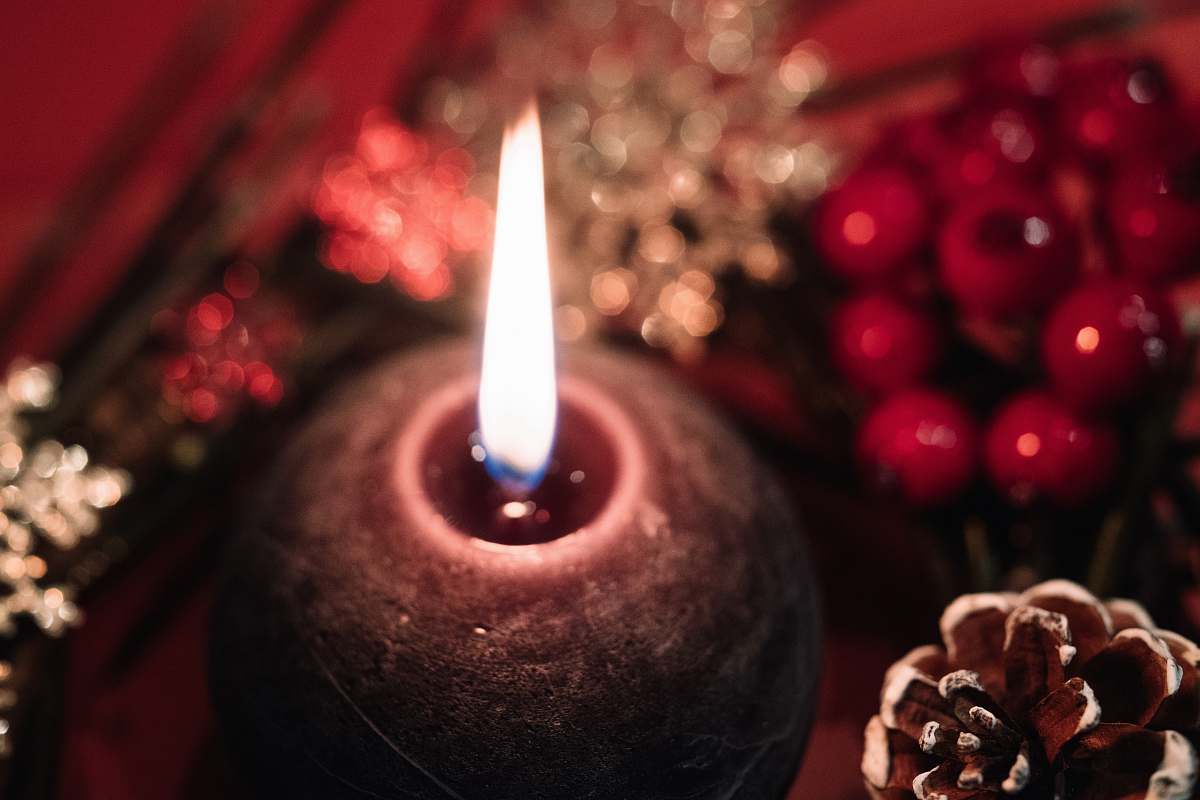 person selective focus photography of flamed candle candle