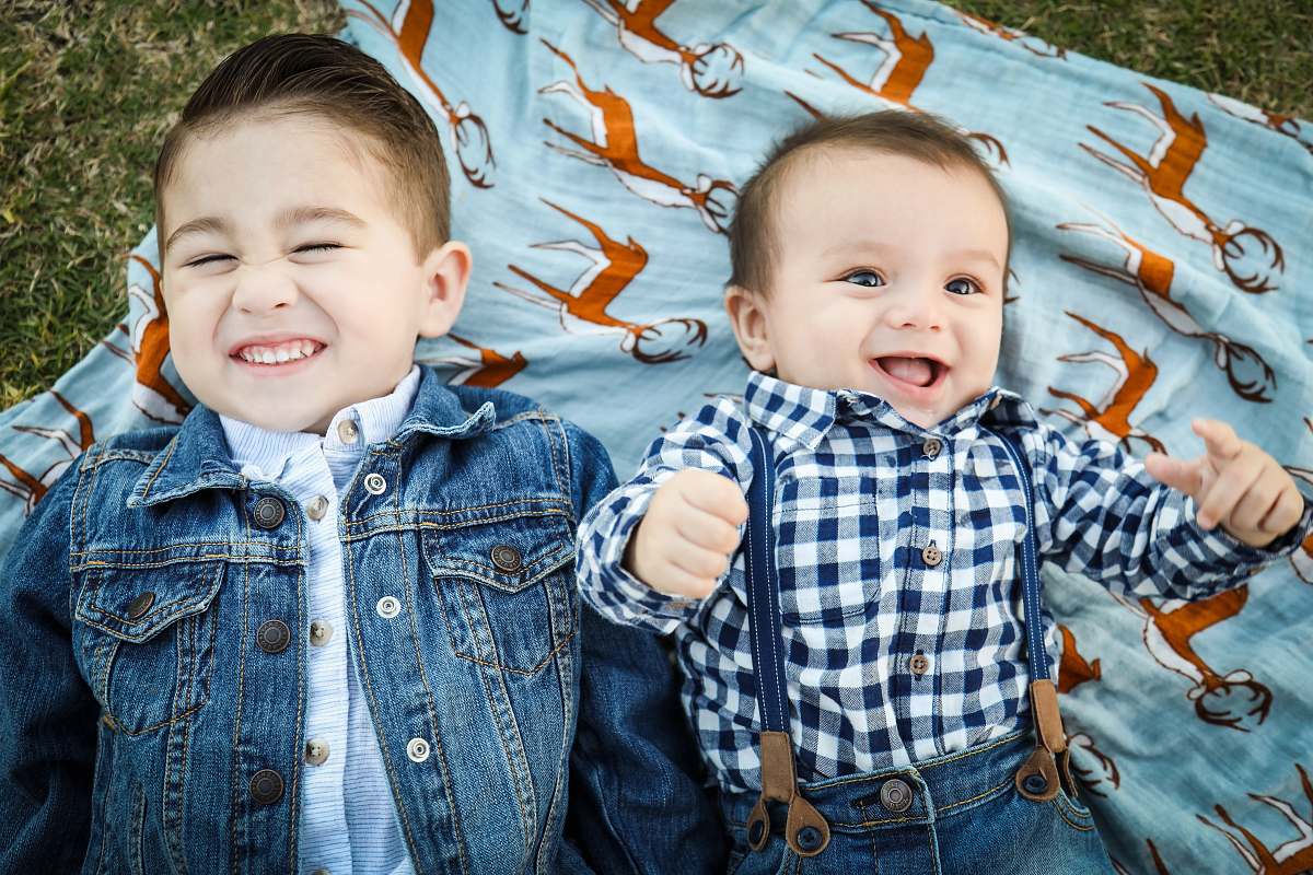 person two boys laying on blue textile people