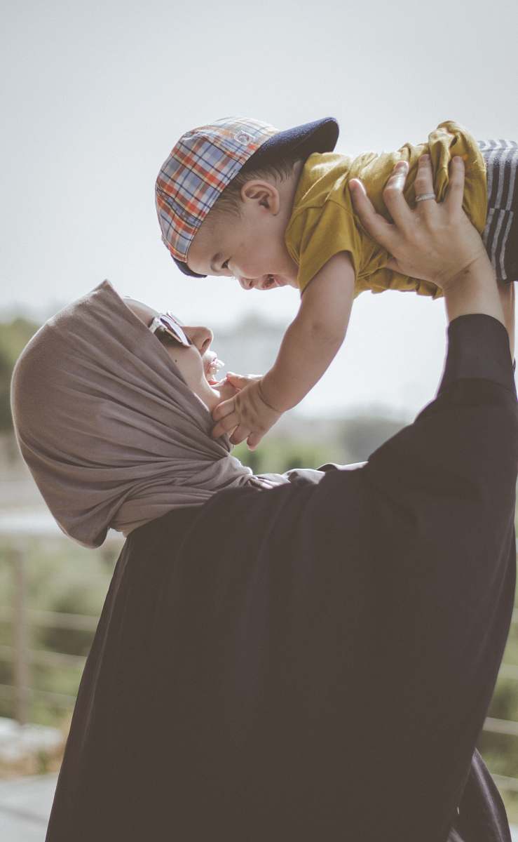 person woman holding boy during daytime people