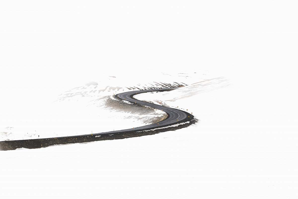 black-and-white free roadway surrounded by snow snow