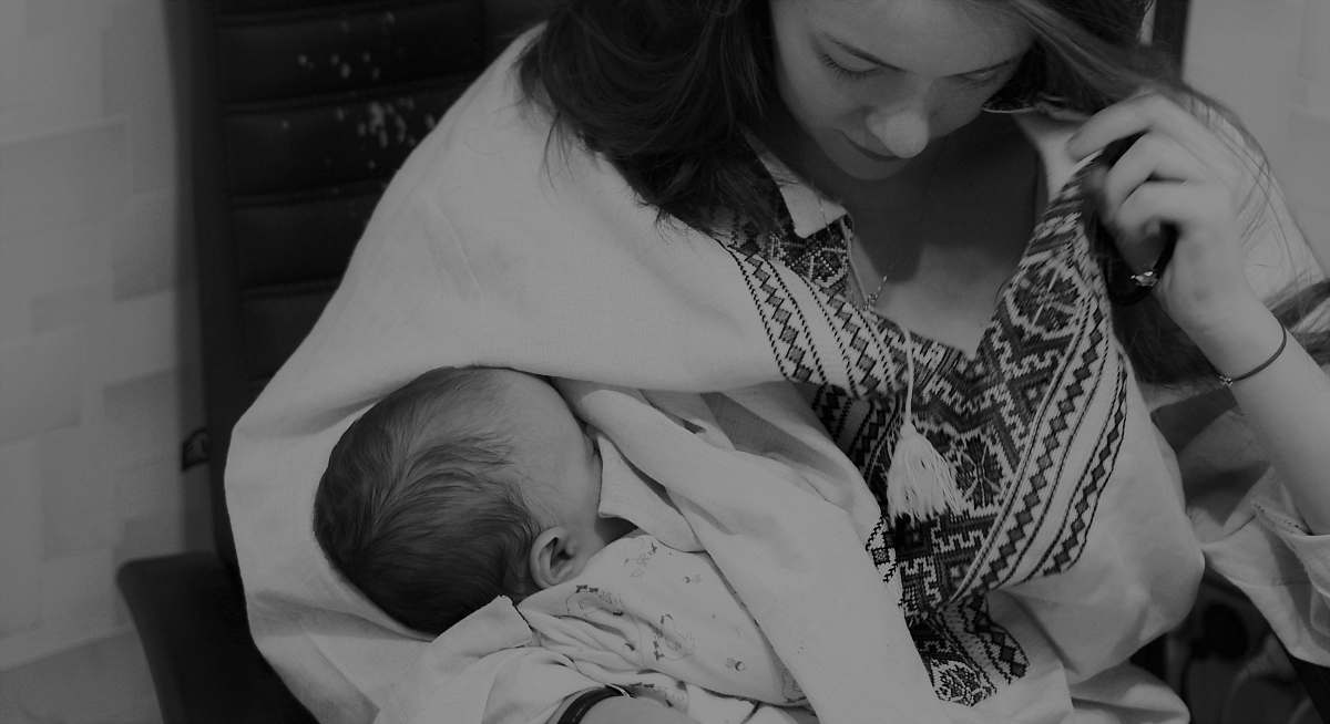 person greyscale photo of woman carrying baby black-and-white