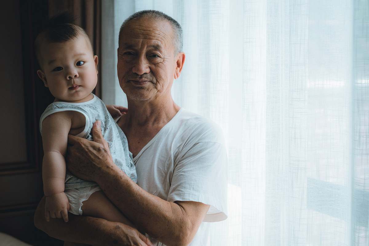 human man carrying baby wearing white shirt baby