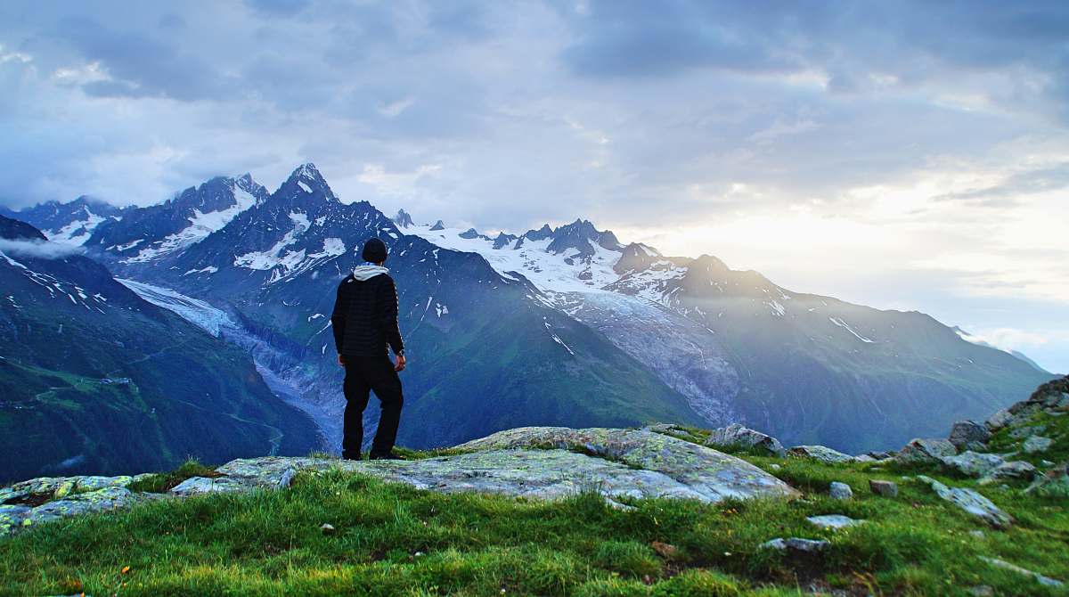 nature person standing in front of mountain landscape photography alps