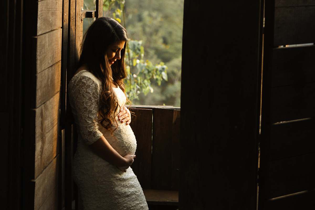 human pregnant woman holding her womb girl