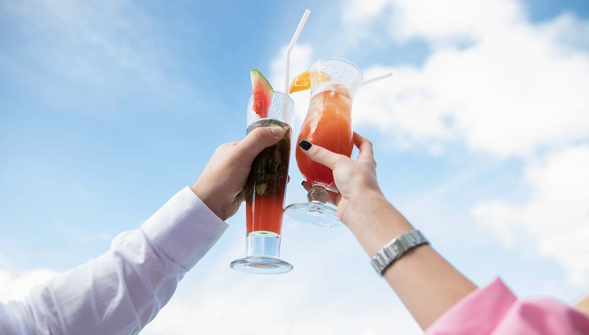 drink two person holding clear drinking glasses maldives
