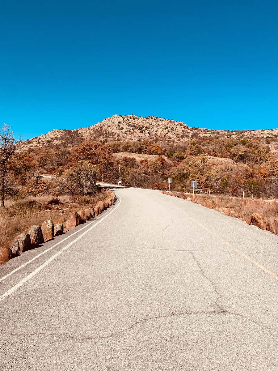 tarmac gray concrete road near mountain freeway