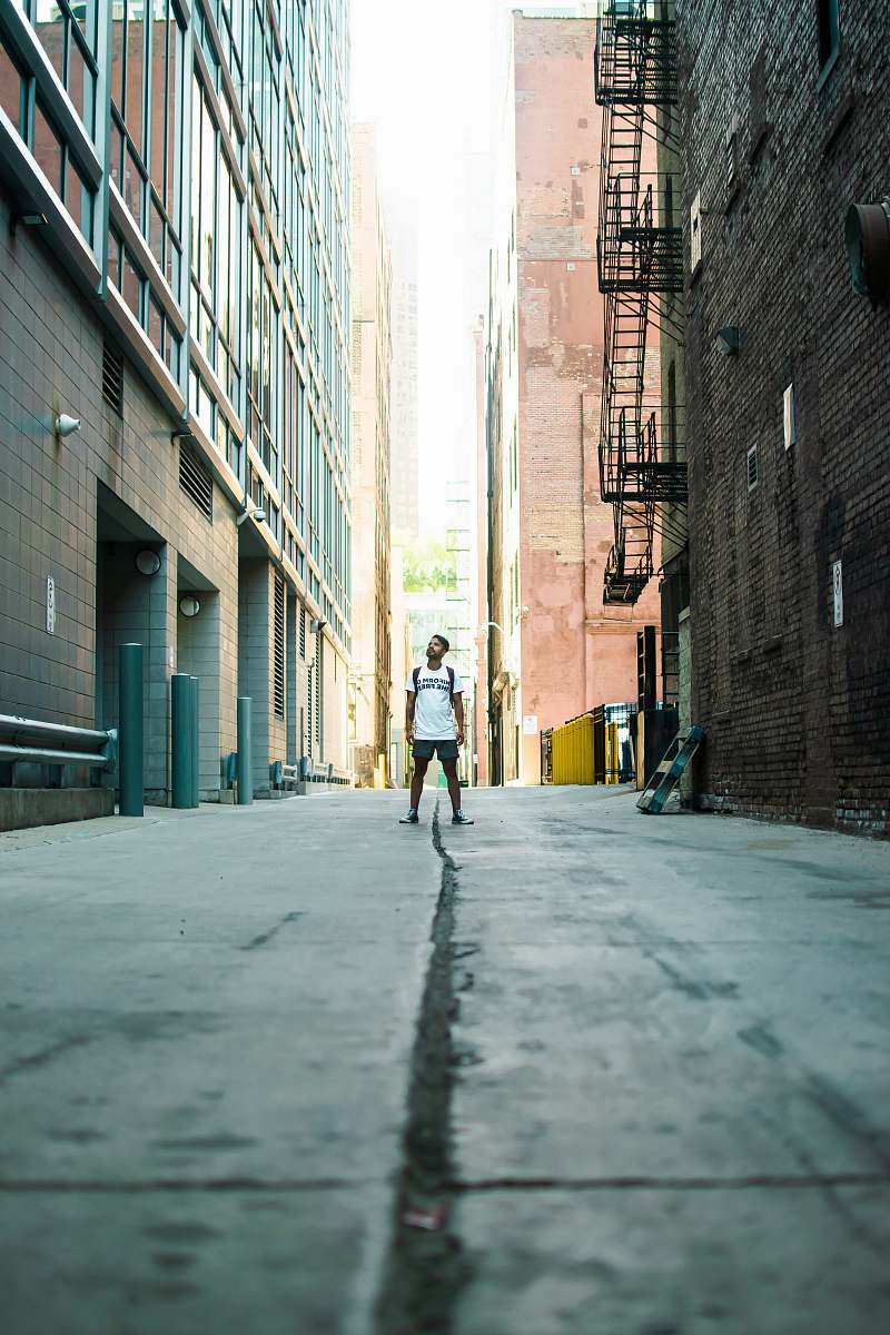 city man standing in middle of road during daytime urban