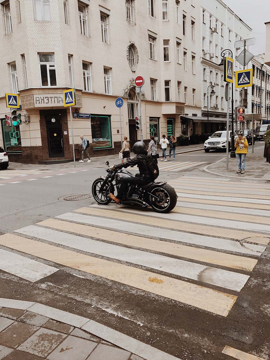 asphalt person rides motorcycle tarmac