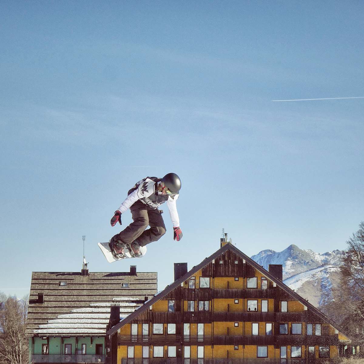 sports snowboard hanging on air near house nature