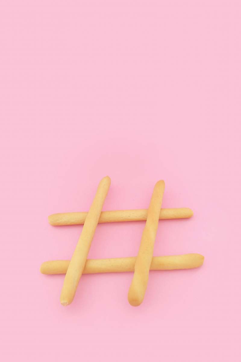 food four brown wooden sticks on pink surface pink