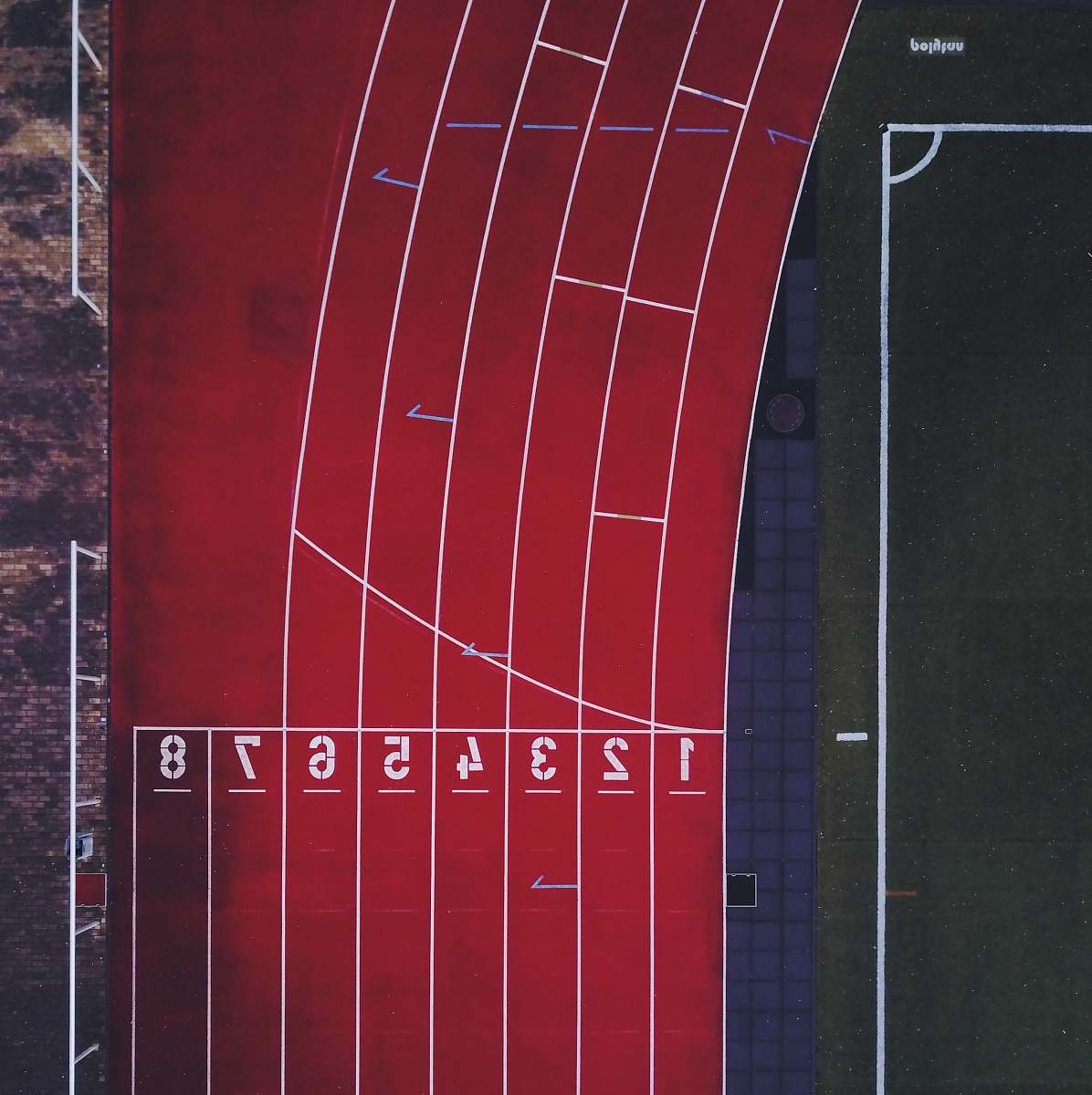 running aerial photo of track and field race track red