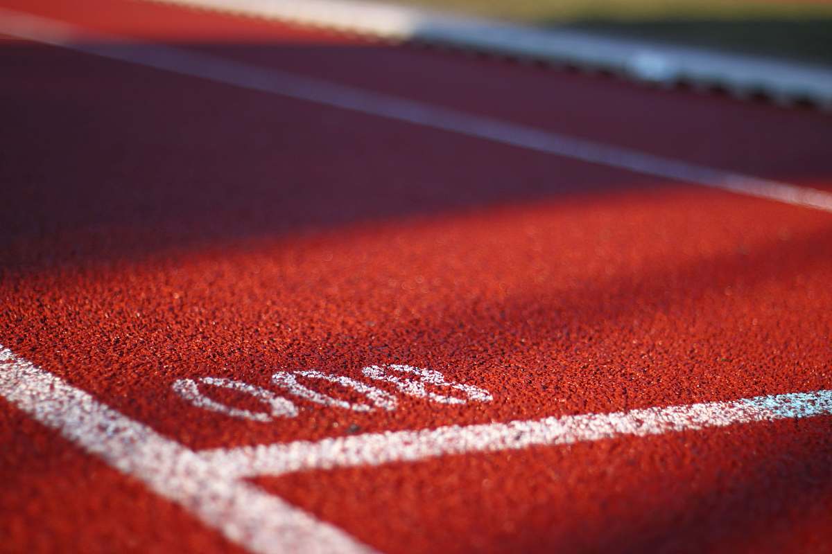 red low angle photography of track field running