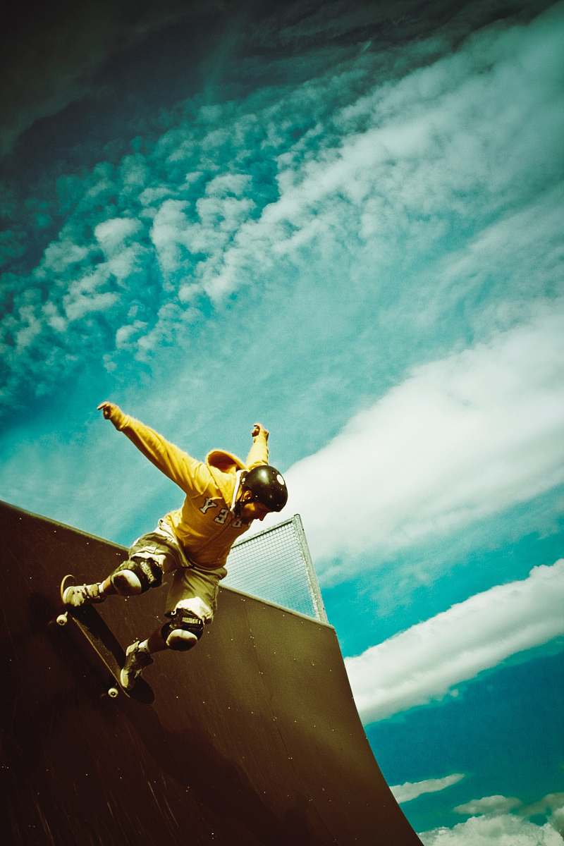 skateboarder man doing skateboard trick skatepark