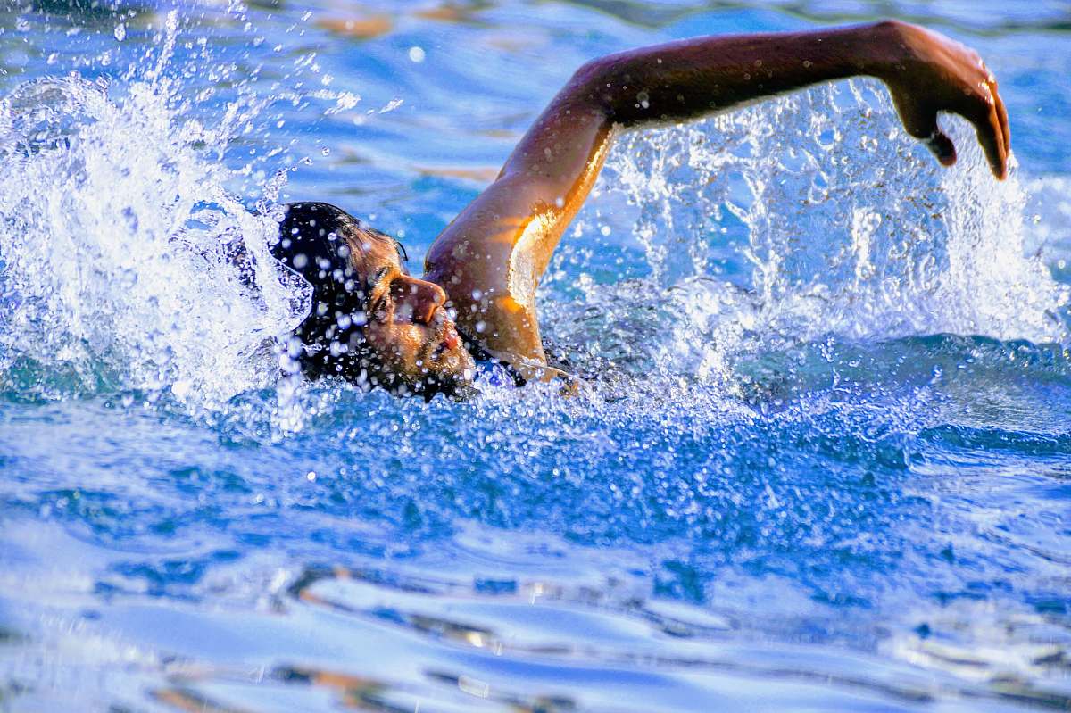 water man swimming in body of water swimming