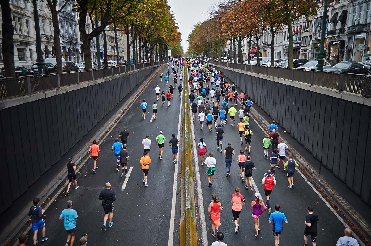running people running on road during daytime marathon