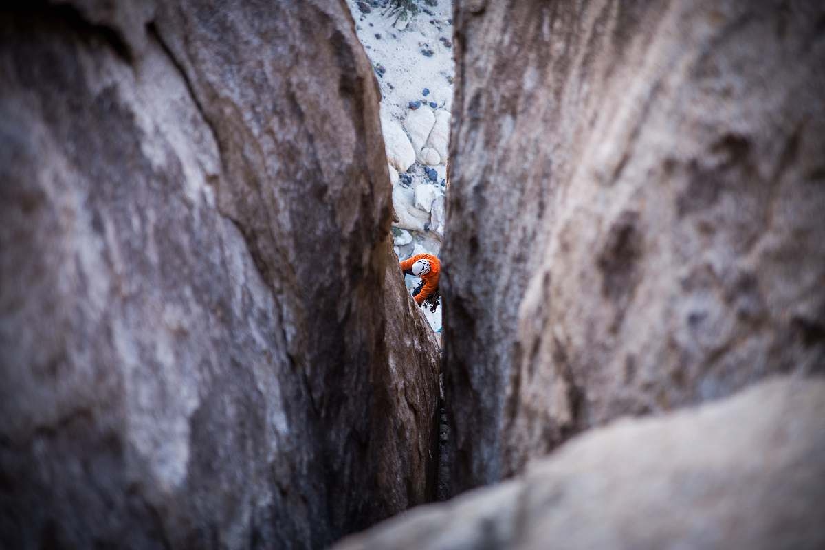 outdoors person climbing on rock during daytime climbing